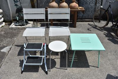 three chairs and a table on the ground