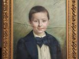 portrait of a young boy in a blue jacket and bow tie