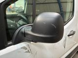 a side view mirror of a white truck with a broken window