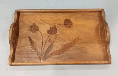 a wooden tray with flowers on it on a wall