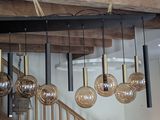many lights hanging from the ceiling in this room