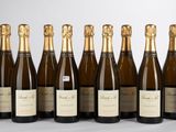 six bouteilles de vin sont alignées sur une table