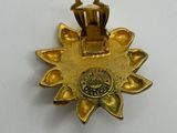 a close up of a gold medal on a white surface