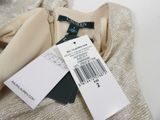a label on the back of a dress with a price tag on it