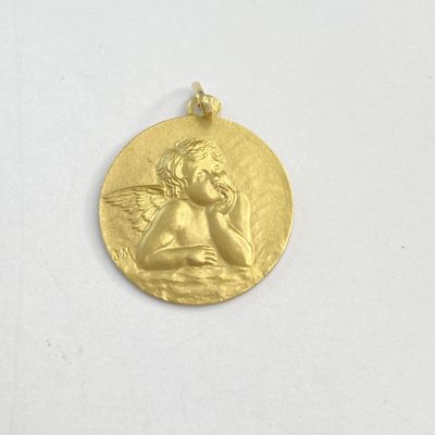 une image représentant une médaille d'or sur laquelle figure un petit ange