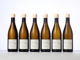 six bottles of wine lined up in a row on a table