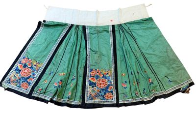 an image of a green skirt with blue and white flowers on it