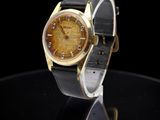 an image of a close up of a wrist watch on a black surface