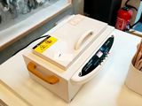 a white counter top with a phone and a box on it