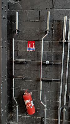 a fire extinguisher next to a fire hydrant in a building