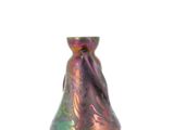 a colorful glass vase sitting on a white surface