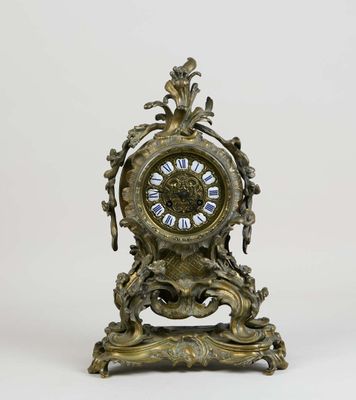 a clock that is sitting on a stand on a white surface