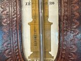 an old fashioned thermometer on display in a room