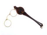 a brown horn shaped object with a gold ring on top of it