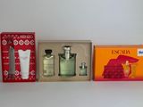 four different types of perfumes are lined up on a shelf