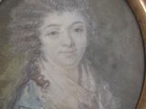 painting of a woman in a blue dress in a gold frame