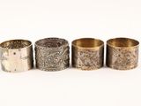 four different types of silver napkins are lined up in a row