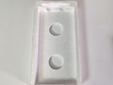 a white box with three buttons on it on a table