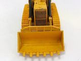 a yellow toy bulldozer on a white surface