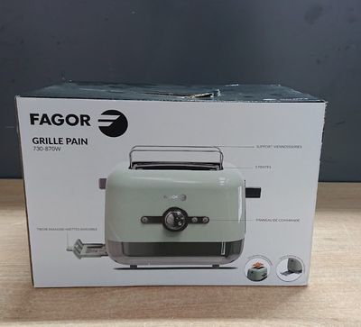 the box of a green toaster sitting on top of a wooden table