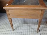 a desk with a chalk board on it in a room
