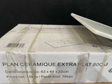 a white plate sitting on top of a box on a table