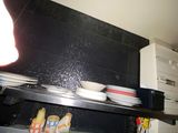 many plates and bowls on a shelf in a kitchen