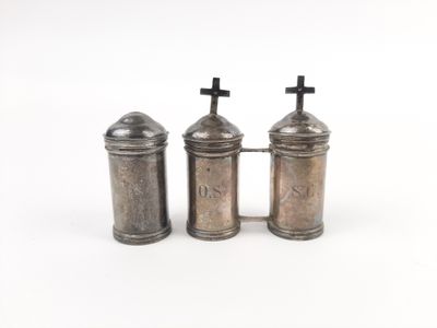 two silver salt and pepper shakers with crosses on top