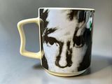 a close up of a coffee cup with a picture of a man on it