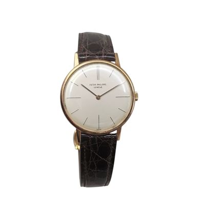 a close up of a watch on a white background with a black strap