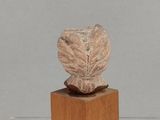 an image of a sculpture of a head on a wooden stand