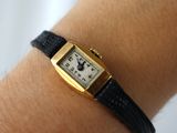 a woman ' s wrist that has a watch on it