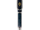 a close up of a pen with a black and gold design on it