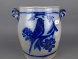 a blue and white vase with a bird on it