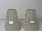two vases that are sitting on a white table