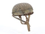 a helmet hanging from a tree branch in the snow
