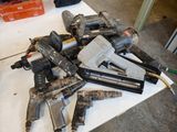 many different types of nail guns sitting on a table