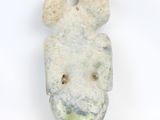 a stone sculpture of a face on a white surface