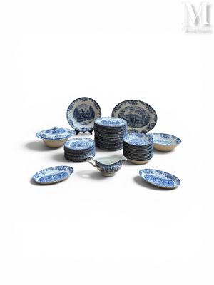 a pile of blue and white plates on a white surface