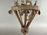 sculpture of a lamp with animals on top of it on a wooden stand