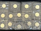 a lot of gold coins in bags on the table