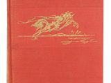 a red book with a gold horse on the cover