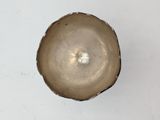 a close up view of a brown bowl on a white surface