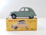 a green toy car sitting on top of a box