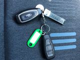 a car key and remote control on the seat of a car