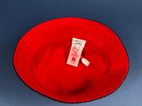 a red plate with a tag on it sitting on a blue surface