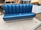 a blue couch that is sitting on the ground