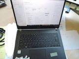 a laptop computer sitting on top of a wooden table
