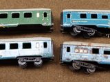 four toy train cars sitting on top of a table next to each other
