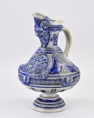 blue and white vase with a bird on it on a white background